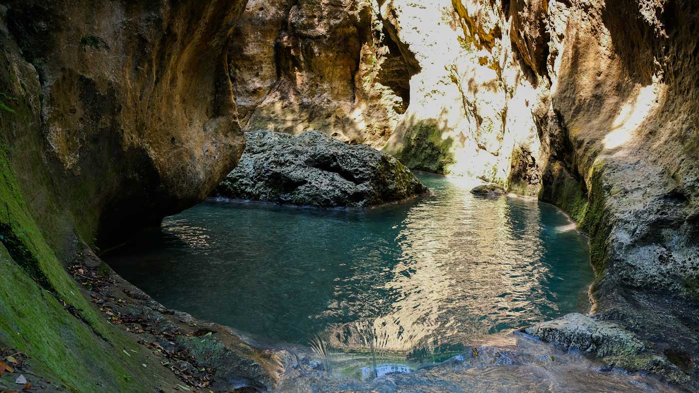 Pool surrounded by cliffs at Bassin Bleu waterfall, Jacmel