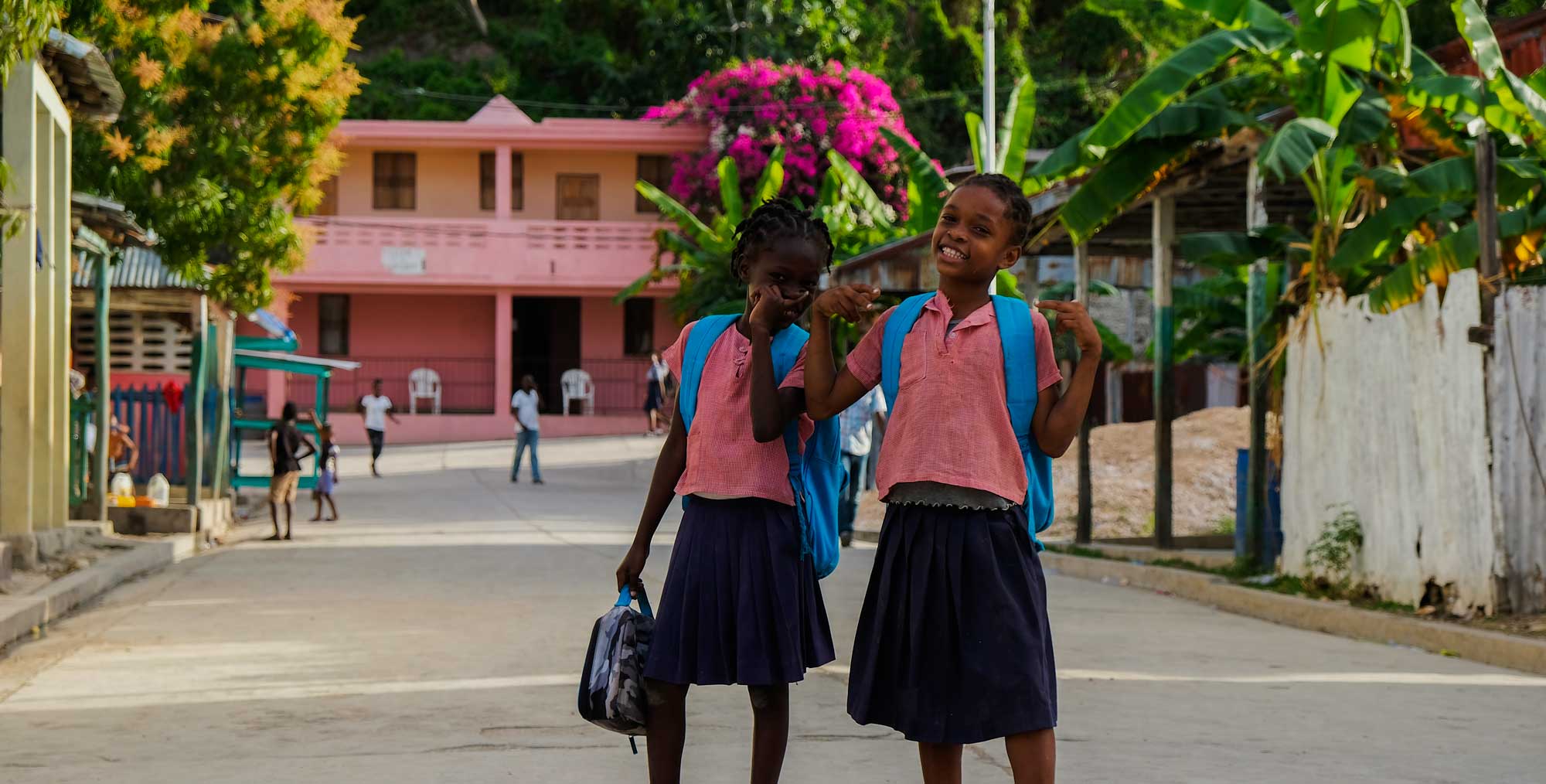 Two schoolgirls laughing in Corail, Haiti