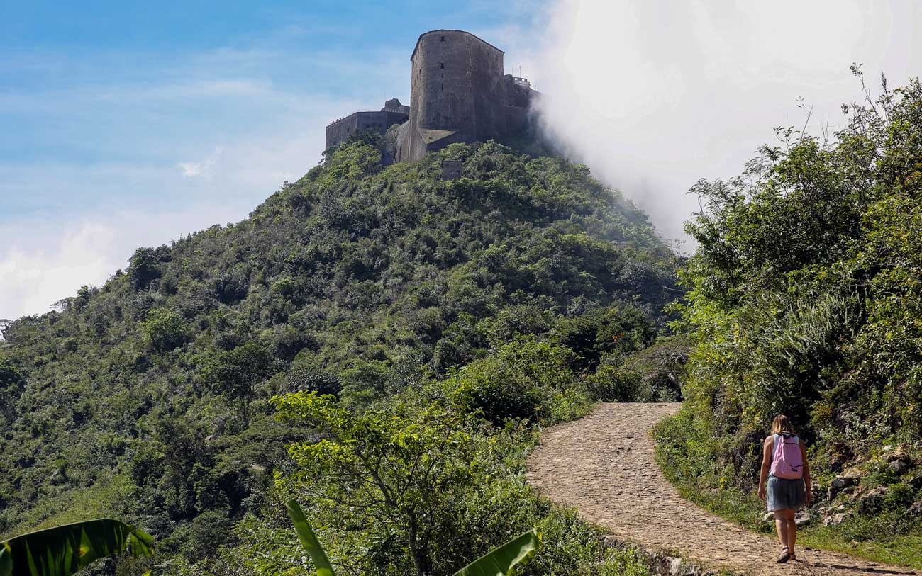 A woman hikes up the path to Citadelle Laferrière, Haiti