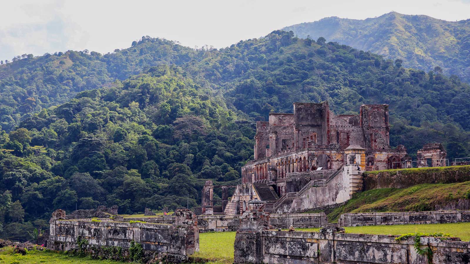 Sans-Souci Palace, Haiti, with tree-covered mountains in the background
