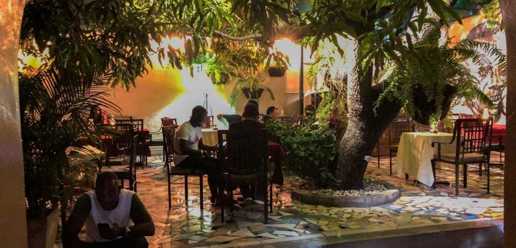 Group eating dinner at Yanvalou in Pacot, Haiti