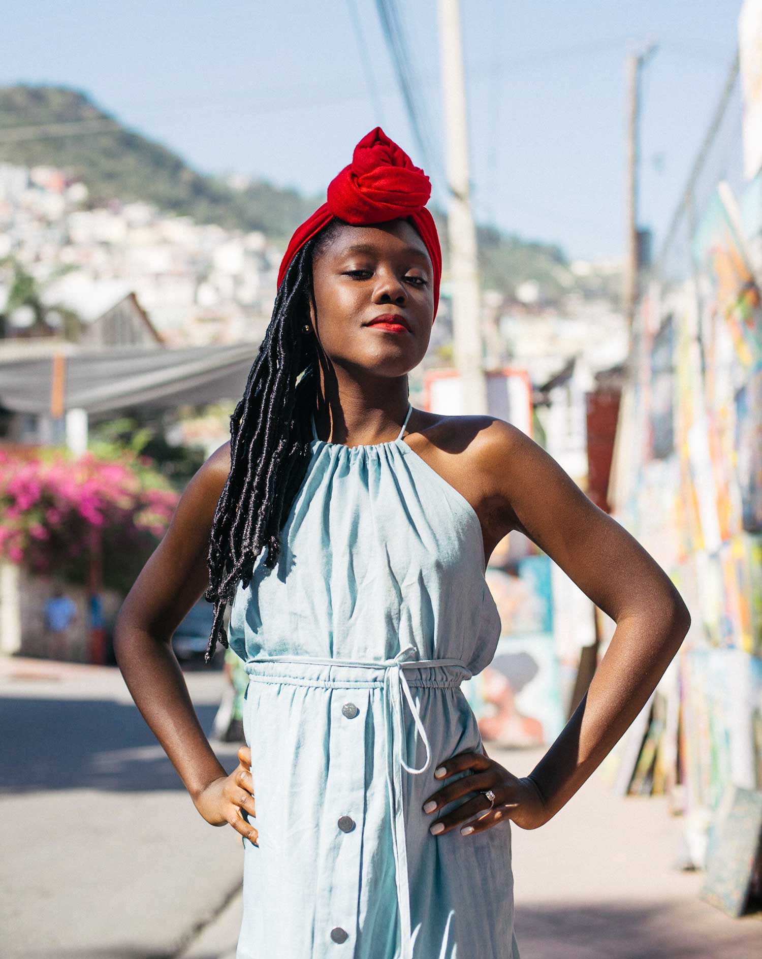 portrait photo of young stylish haitian girl with long dreadlocks and red head scarf