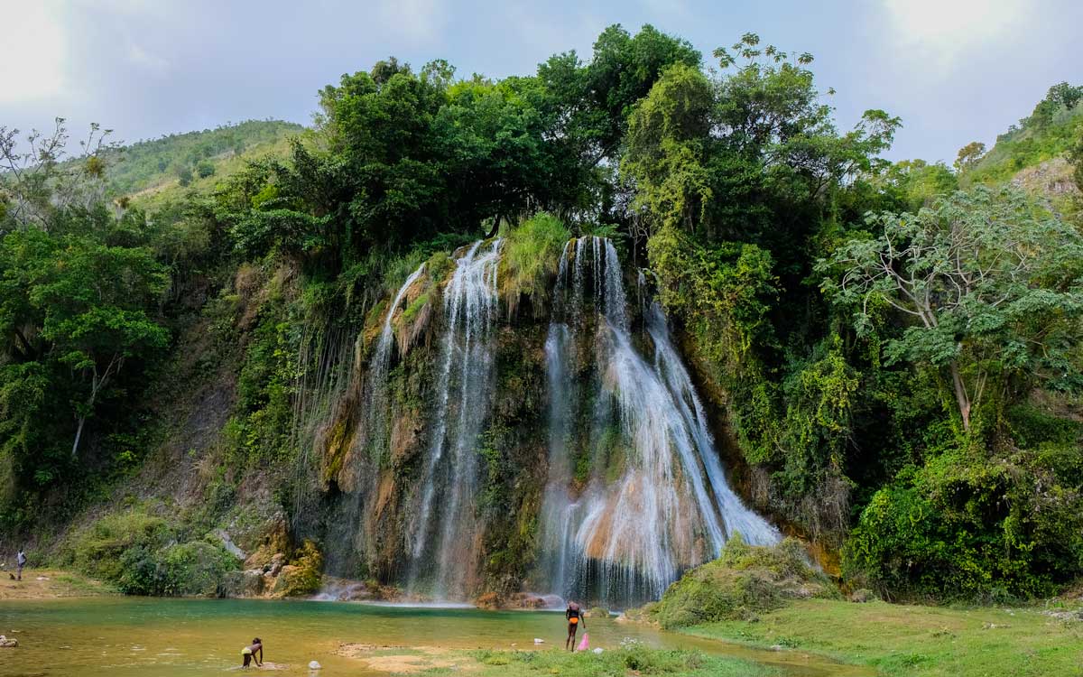 large haitian waterfall splashing into natural pool