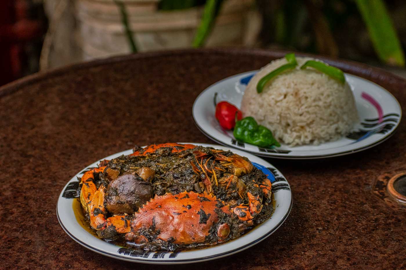 two plates with haitian lalo and rice