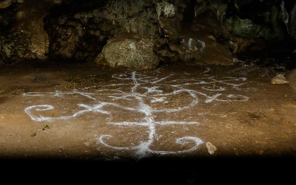 vodou symbol painted on a cave floor