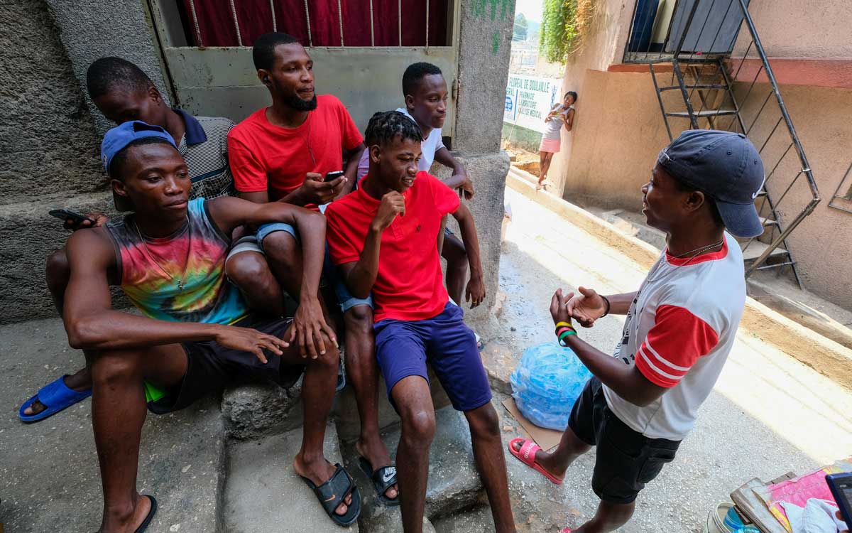 haitian boys sitting in port-au-prince