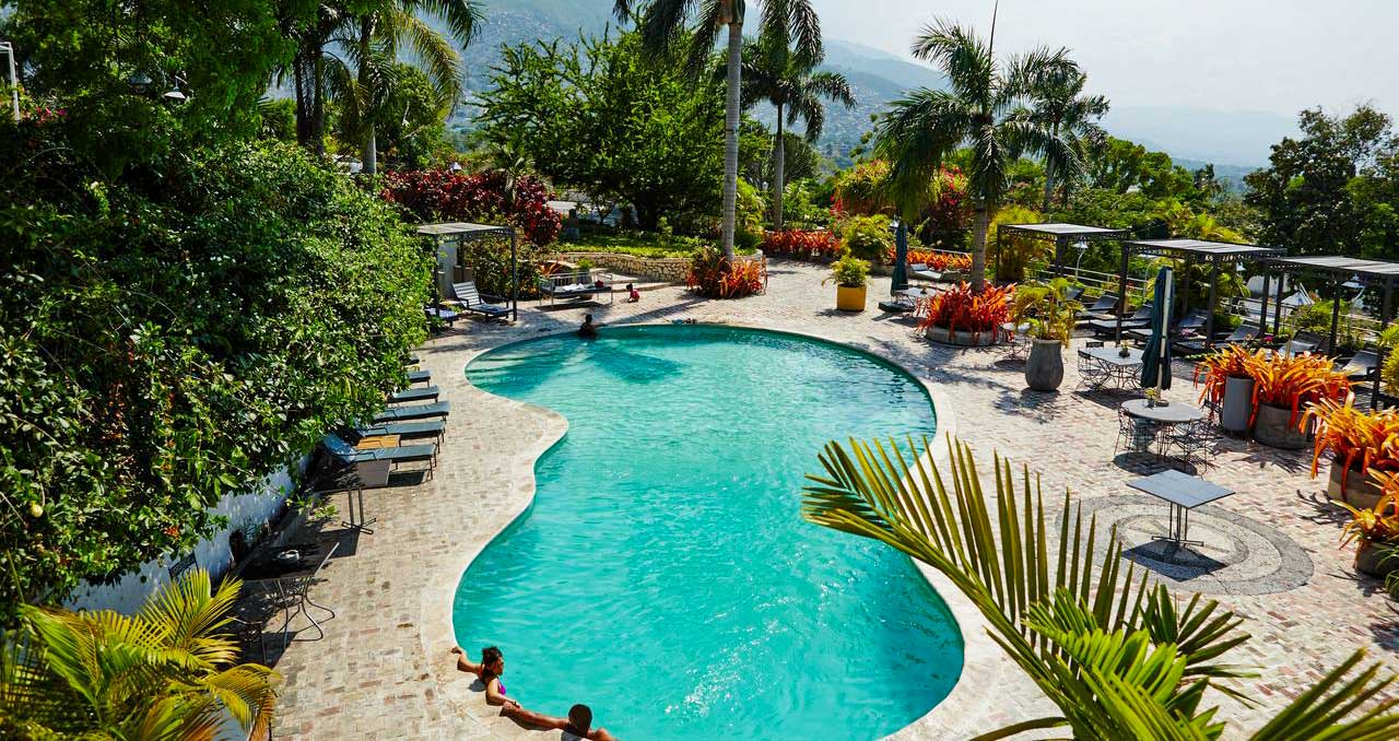 hotel pool area with lush garden