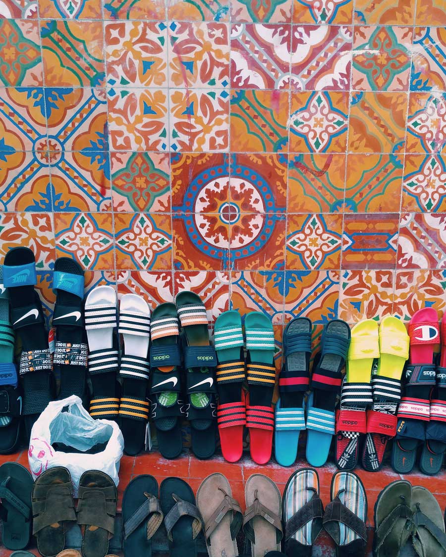 sandals on display on a tiled wall