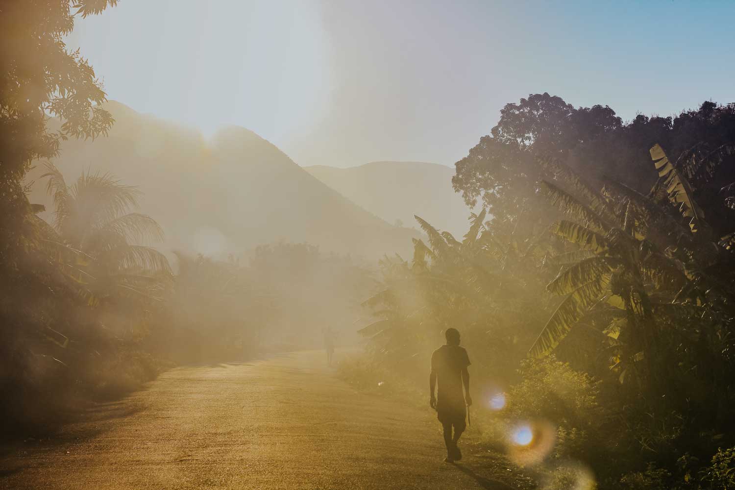 haitian man walking during sunrise in saint-marc