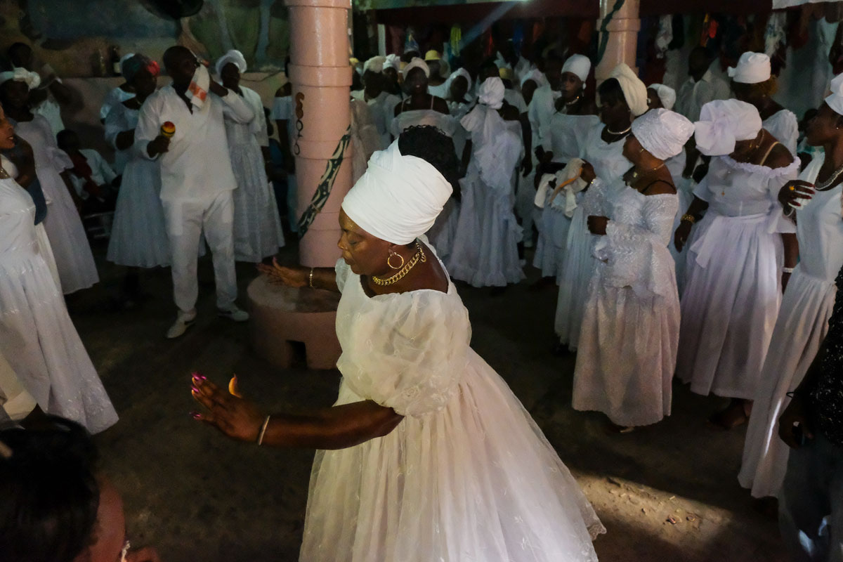 a group of vodou practitioners dressed in white