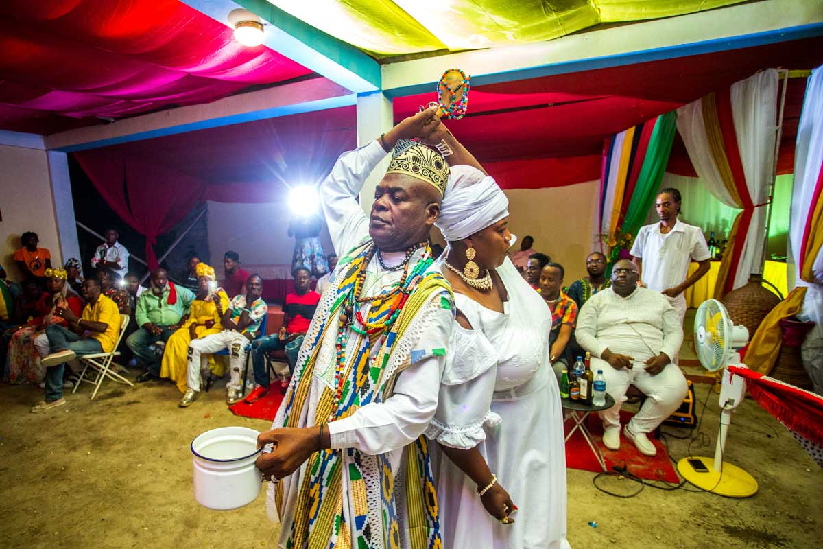 a vodou priest and practitioner performing a dance