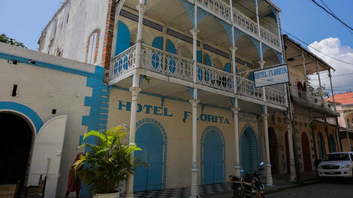 facade of old colonial hotel painted white and bright blue