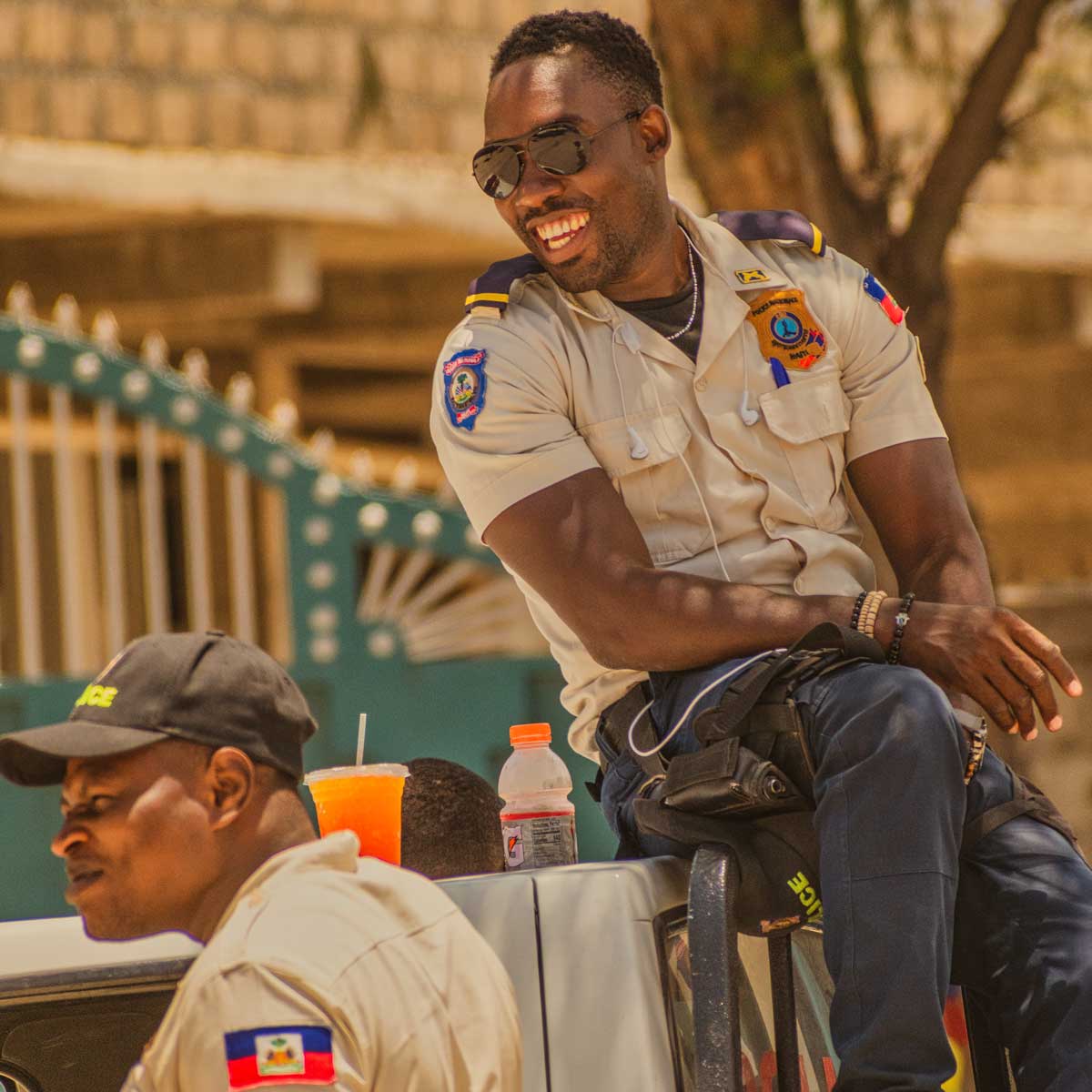 two haitian police men smiling