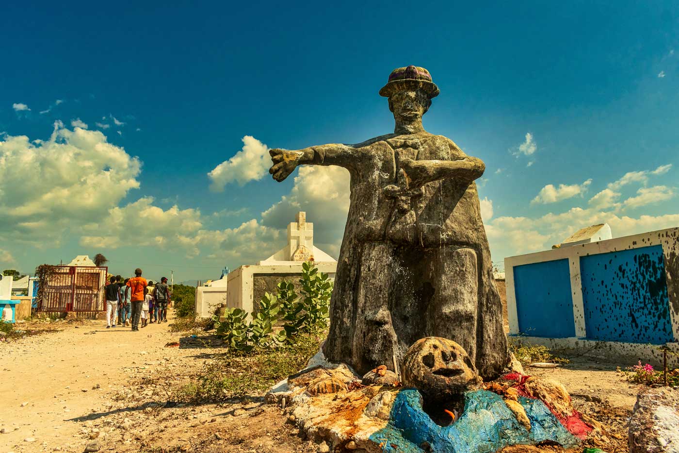 haitian cemetery with sculpture and blue sky with clouds