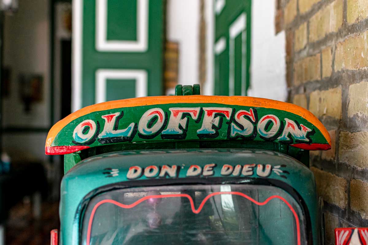 handpainted toy bus with Hotel Oloffson logo